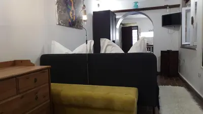 a living room with a couch and a yellow stool at Antica Trasteverina in Rome
