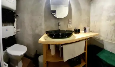 a bathroom with a black sink and a toilet at Antica Trasteverina in Rome