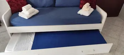 a bed with two pillows on top of it at Malu's house in Rome