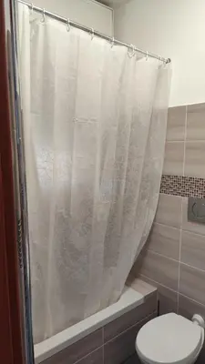 a shower curtain in a bathroom with a toilet at Malu's house in Rome