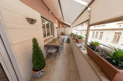 an indoor balcony with tables and potted plants at Gaia's home in Vatican in Rome
