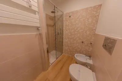 a bathroom with a toilet and a glass shower at Gaia's home in Vatican in Rome