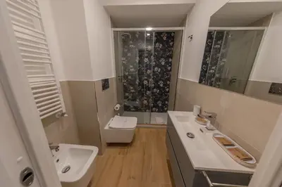 a bathroom with a sink and a toilet and a shower at Gaia's home in Vatican in Rome