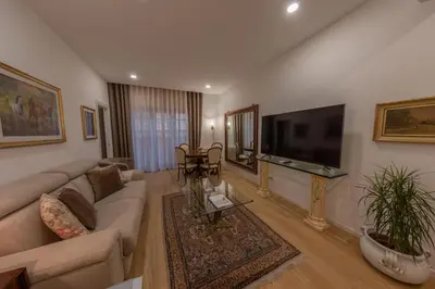 a living room with a couch and a flat screen tv at Gaia's home in Vatican in Rome