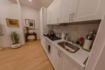 a kitchen with white cabinets and a sink at Gaia's home in Vatican in Rome