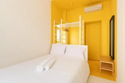 a bedroom with a white bed with towels on it at Reale Vatican House in Rome