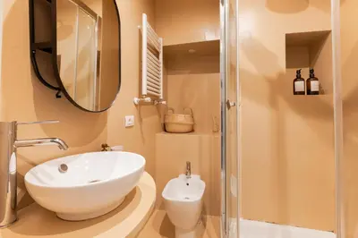 a bathroom with a white sink and a mirror at Reale Vatican House in Rome