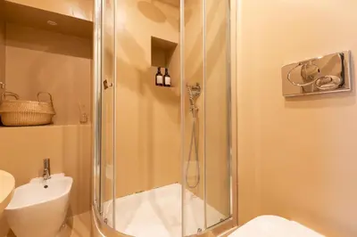 a bathroom with a shower with a toilet and a sink at Reale Vatican House in Rome