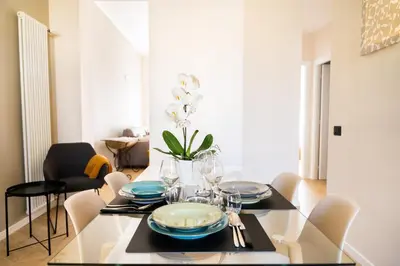 a dining room with a glass table and chairs at Testaccio Design Apartment Rome in Rome