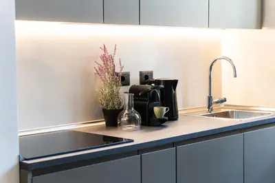 a kitchen with a sink and a counter top at Testaccio Design Apartment Rome in Rome