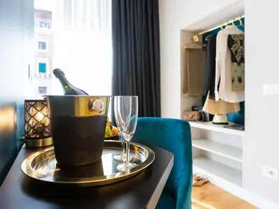a table with a bottle of wine and a glass at Regola Luxury Relais in Rome