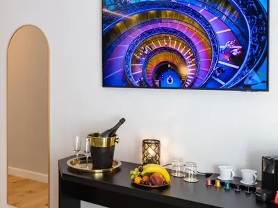 a table with a bowl of fruit and a painting on the wall at Regola Luxury Relais in Rome