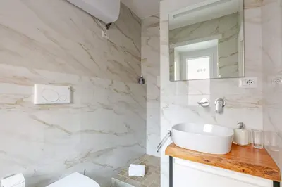 a white bathroom with a sink and a mirror at Roma Vatican City in Rome