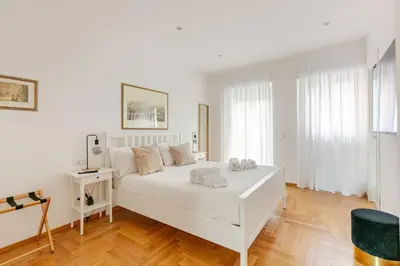 a white bedroom with a large white bed in a room at Roma Vatican City in Rome