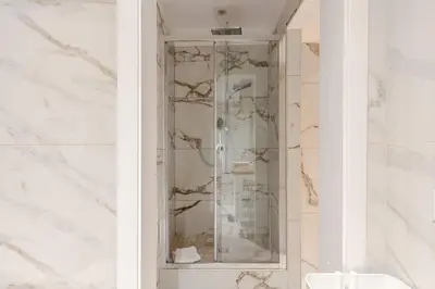 a shower with a glass door in a bathroom at Roma Vatican City in Rome