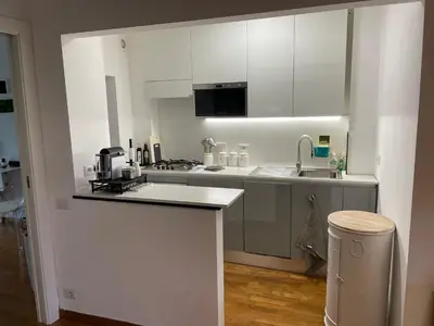 a kitchen with white cabinets and a counter top at Loft 643 in Rome