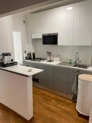 a kitchen with white cabinets and a white counter top at Loft 643 in Rome