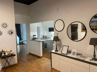 a living room with a kitchen and a counter with mirrors at Loft 643 in Rome