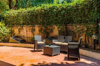 a group of chairs and a table on a patio at Caracalla garden House in Rome