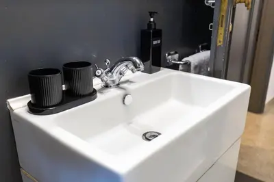 a white sink with two cups on top of it at Caracalla garden House in Rome