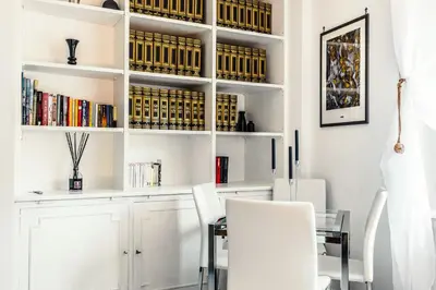 a dining room with white cabinets and a table and chairs at Caracalla garden House in Rome