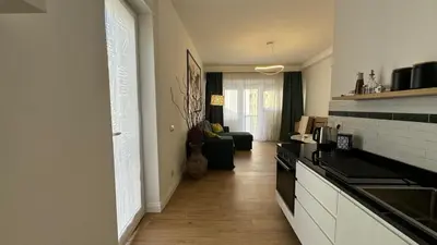 a kitchen with a stove and a living room at A casa di Ren in Rome