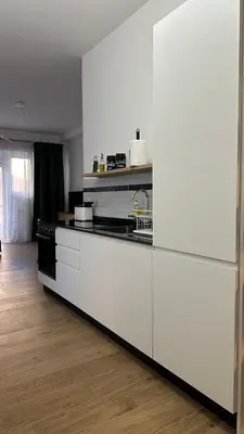 a kitchen with white cabinets and a stove at A casa di Ren in Rome