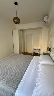 a bedroom with a large white bed in a room at A casa di Ren in Rome