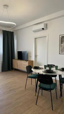 a living room with a table and chairs and a tv at A casa di Ren in Rome