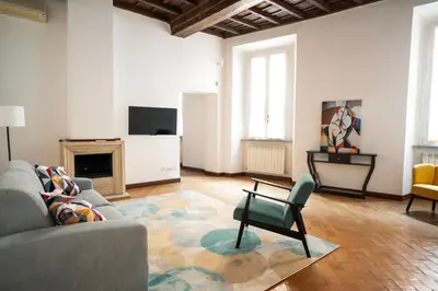 a living room with a couch and a chair at Rome Center Apartment Campo De' Fiori in Rome