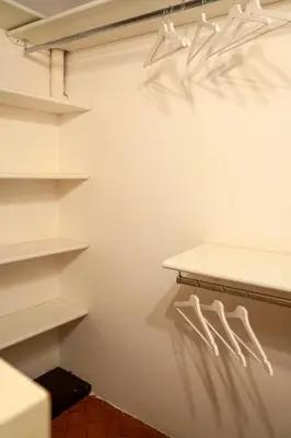 a walk in closet with white shelves at Rome Center Apartment Campo De' Fiori in Rome
