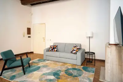 a living room with a couch and a chair at Rome Center Apartment Campo De' Fiori in Rome