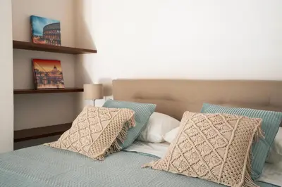 a bedroom with a bed with two pillows on it at Rome Center Apartment Campo De' Fiori in Rome