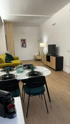 a living room with a table and chairs and a couch at A casa di Edo in Rome