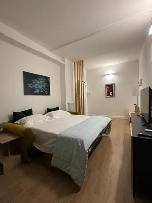 a bedroom with a bed and a television in it at A casa di Edo in Rome
