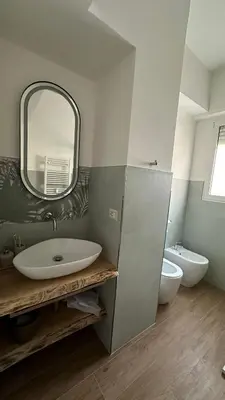 a bathroom with a sink and a mirror and a toilet at A casa di Edo in Rome