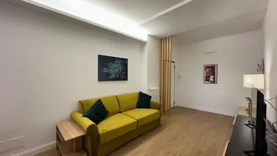 a living room with a yellow couch in a room at A casa di Edo in Rome