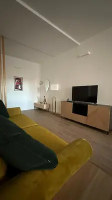 a living room with a couch and a flat screen tv at A casa di Edo in Rome