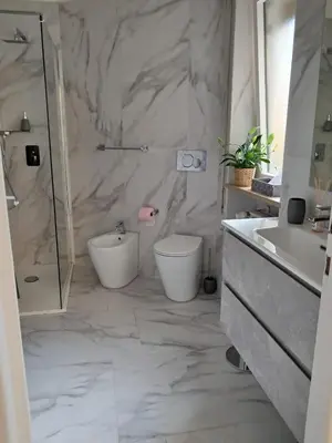 a bathroom with a shower and a toilet and a sink at Le Buganville in Rome