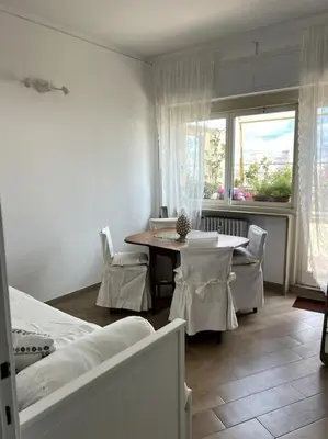 a room with a bed and a table and a window at Le Buganville in Rome