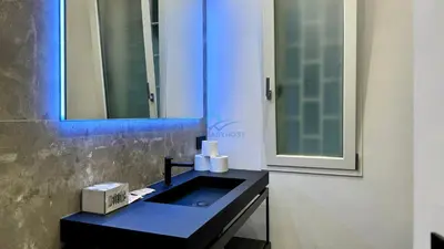 a bathroom with a black sink and a mirror at Chic Studio in piazza Bologna in Rome