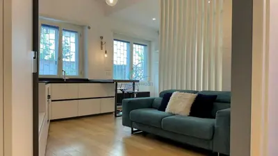 a living room with a couch and a kitchen at Chic Studio in piazza Bologna in Rome