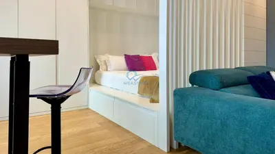 a room with a bed and a chair and a table at Chic Studio in piazza Bologna in Rome