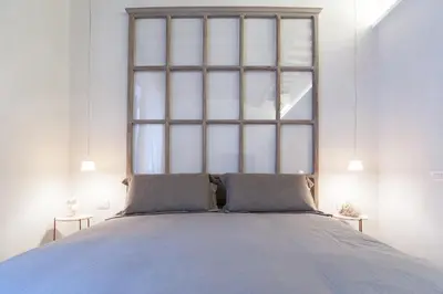 a bedroom with a bed with a large window at Trastevere Luxury, ampia e confortevole location sospesa tra design e storia in Rome