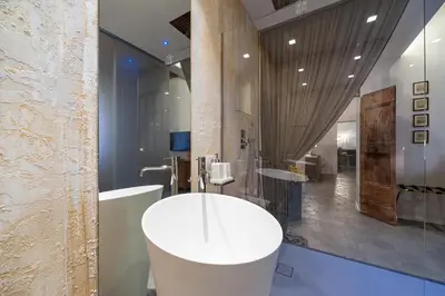 a bathroom with a white tub and a sink at Trastevere Luxury, ampia e confortevole location sospesa tra design e storia in Rome