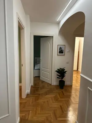 a hallway with a potted plant on a wooden floor at Luxury Apartment Via Veneto in Rome