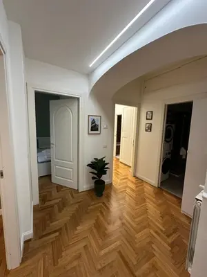 a hallway with a potted plant in a room at Luxury Apartment Via Veneto in Rome