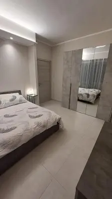 a bedroom with a bed and a large mirror at Holiday Space Roma in Rome