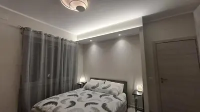 a bedroom with a bed and two lamps and a window at Holiday Space Roma in Rome