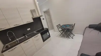 a kitchen with a sink and a table in a room at Holiday Space Roma in Rome